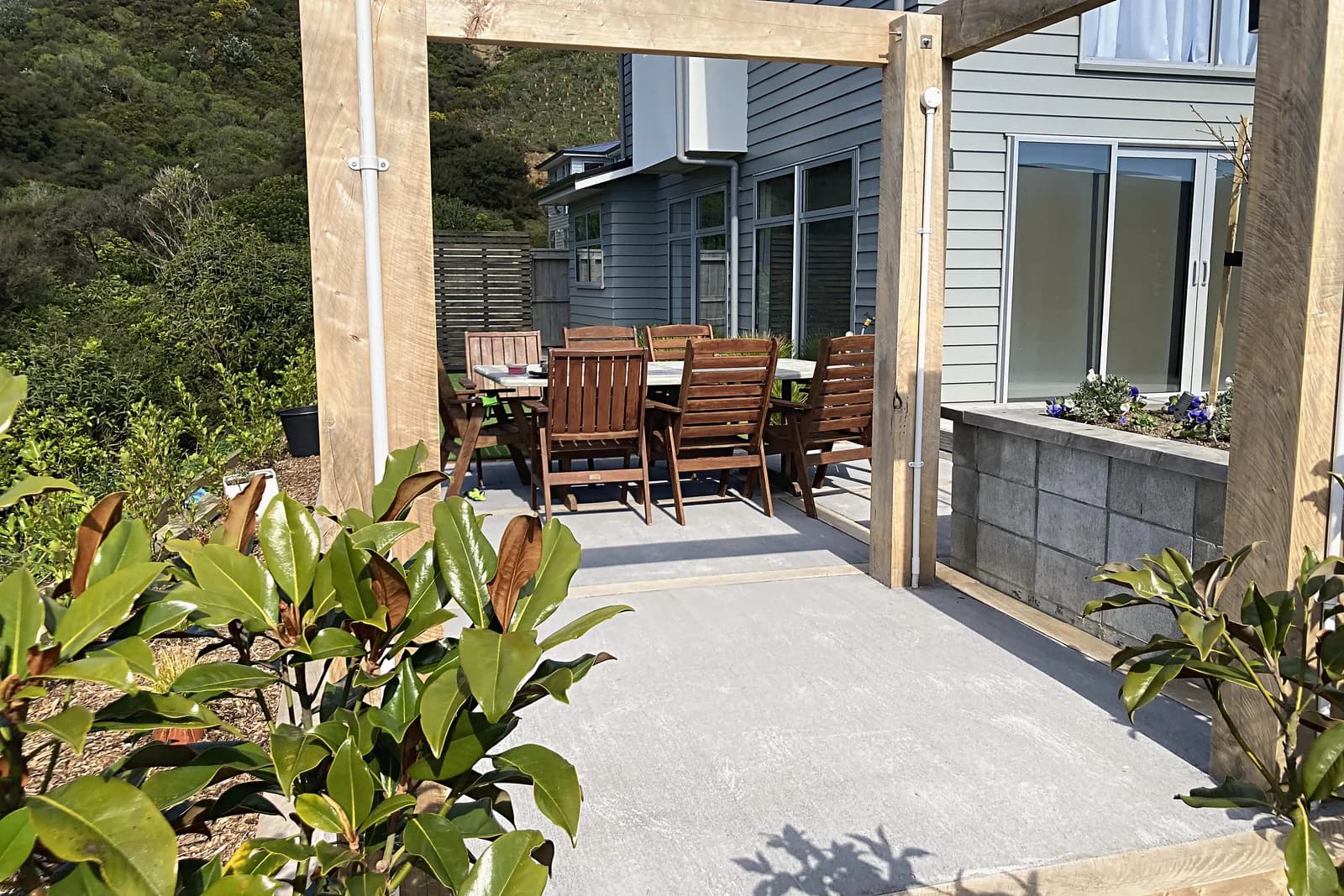 Pergola over a paved terrace with outdoor dining, Aotea