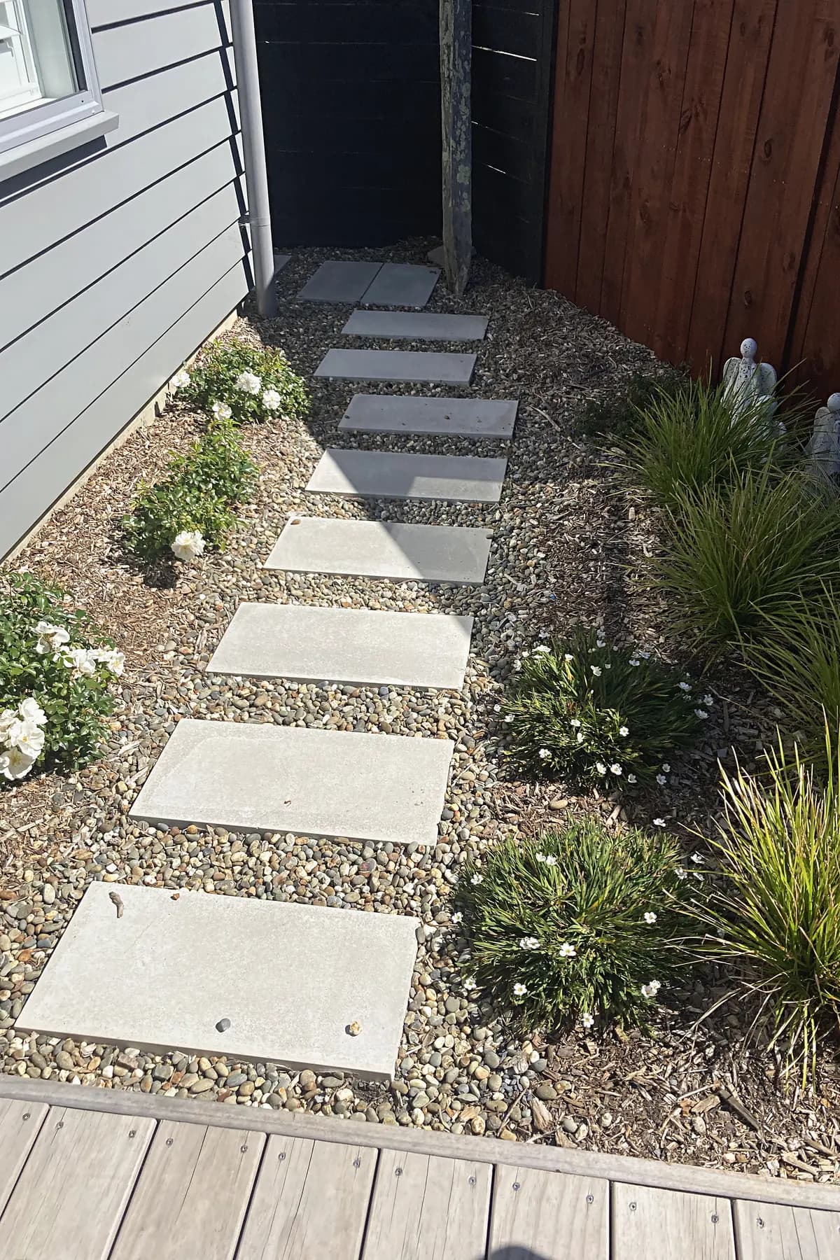 Stepping-stone path through planting beside a house, Aotea