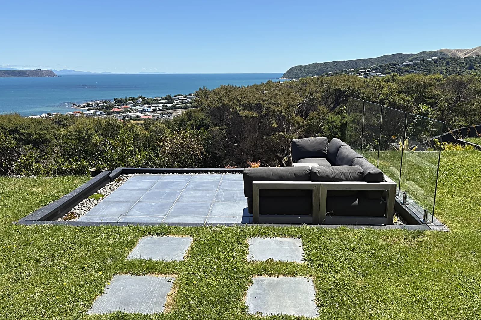 Paved terrace set into a lawn with a sea view, Camborne