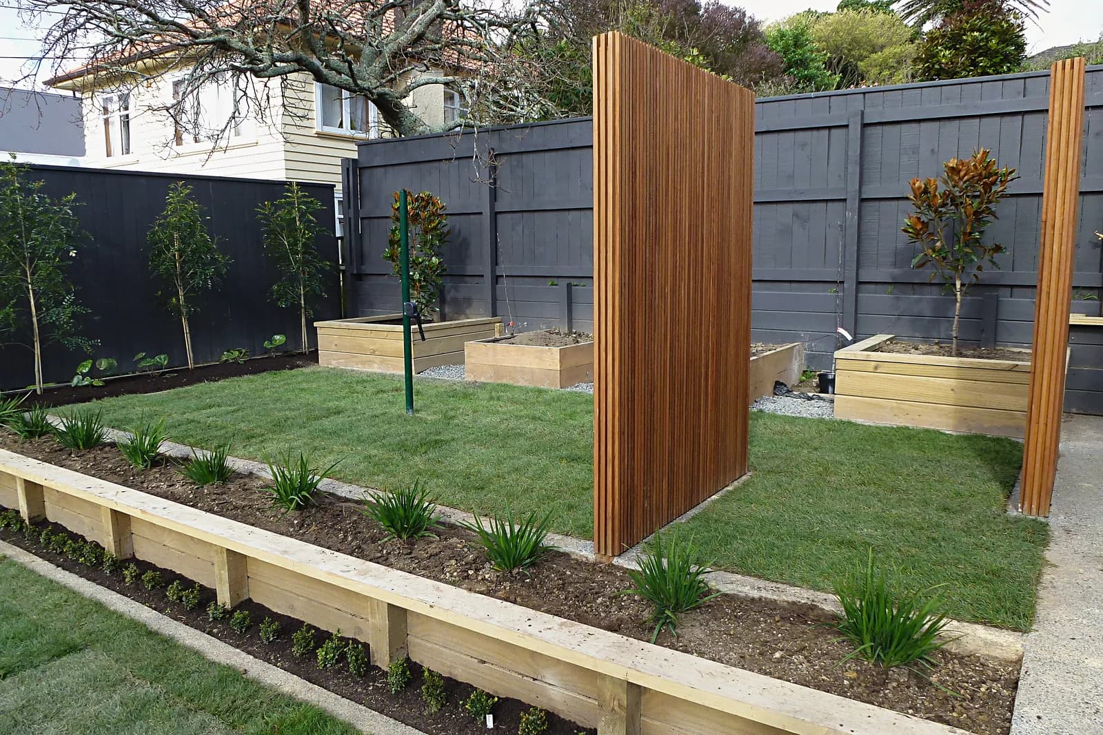 Timber slat screens, raised planters and new lawn, Karori