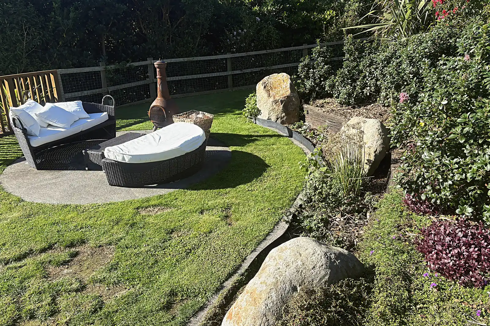 Round paved seating area set in the lawn, Plimmerton