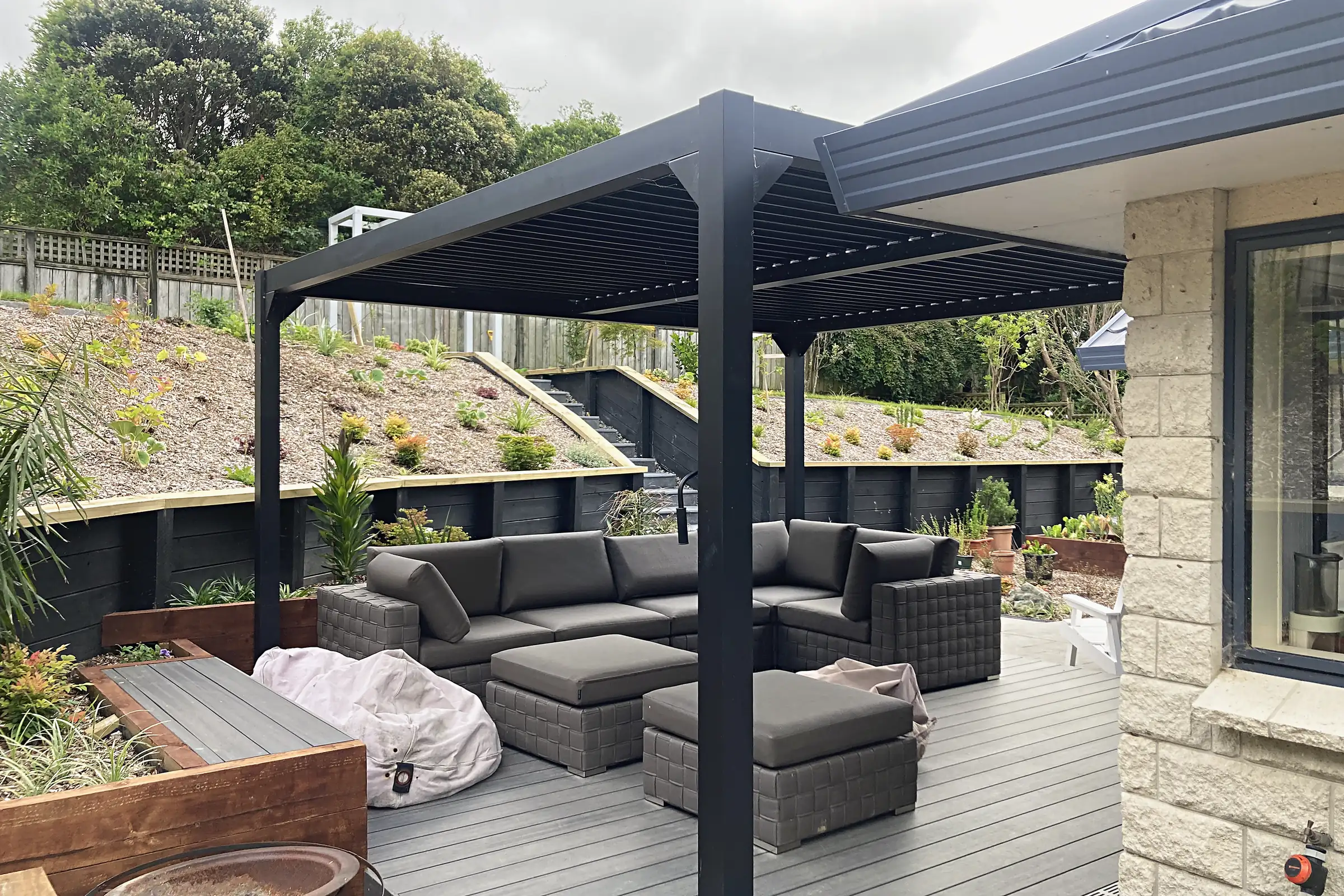 Deck under a louvred roof with retaining terraces behind, Whitby