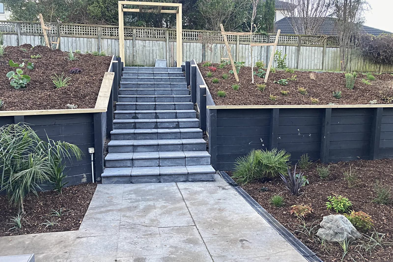 Wide steps between dark timber retaining walls, Whitby
