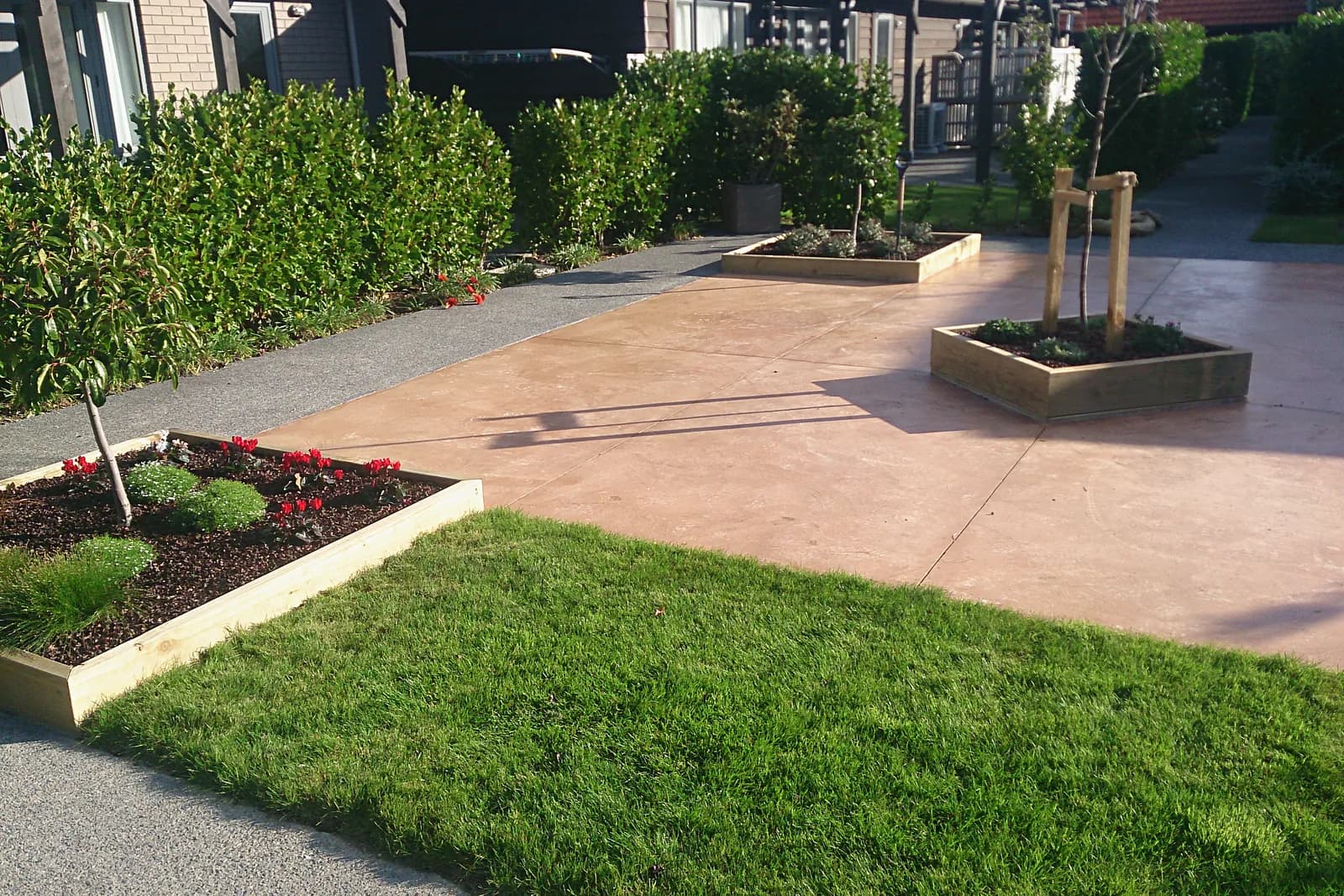 Courtyard with raised timber planters and lawn, Whitby