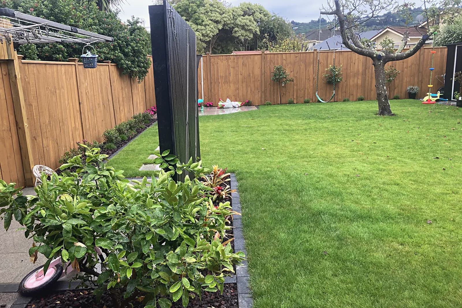 Lawn and garden beds along a timber fence, Woburn
