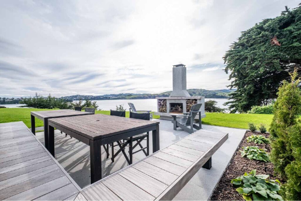 Outdoor fireplace overlooking inlet – Wellington landscaping and outdoor living - Distinctive Home and Landscapes - Paremata Road